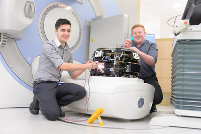 hospital staff repairing a machine