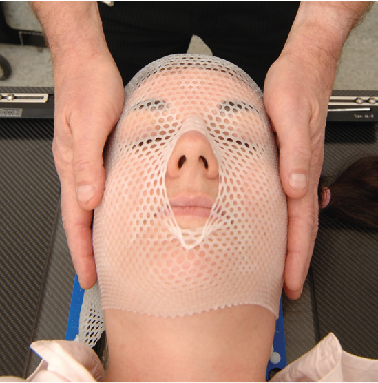 A Photograph of a patient in the Mould Room having a treatment mask made.