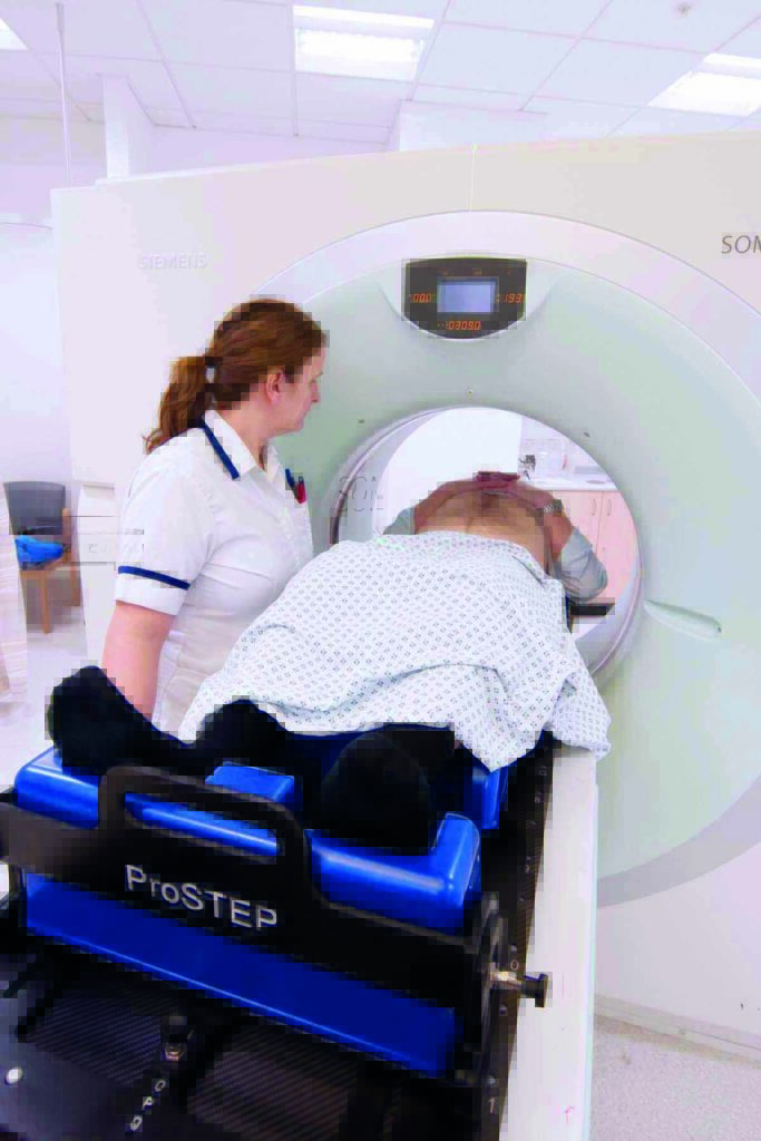 Photograph of a patient having a planning CT scan on a CT scanner.