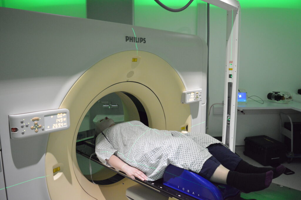 Photograph of a patient having a planning CT scan on a CT scanner.