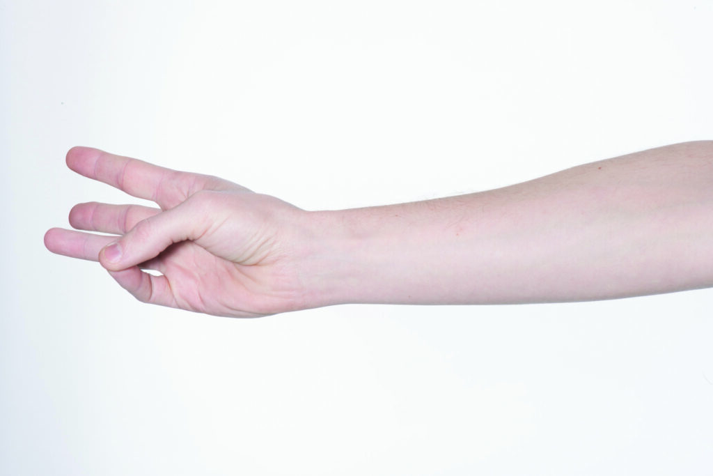 Photograph of a persons hand with fingers out stretched and thumb tapping fingers