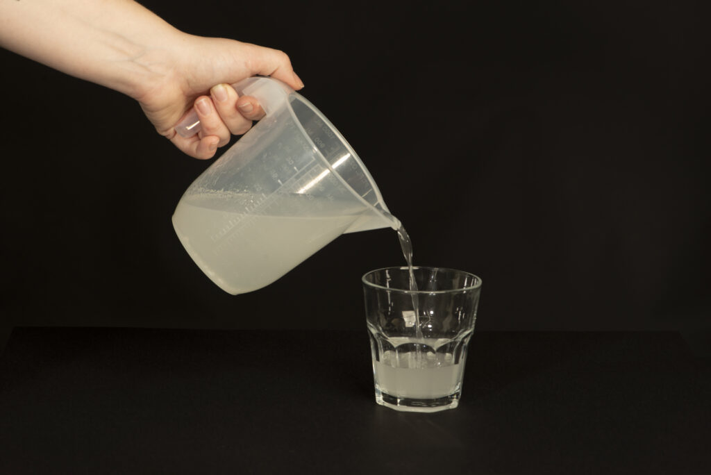 Photograph of the MOVIPREP&reg; drink being poured from a jug into a glass.