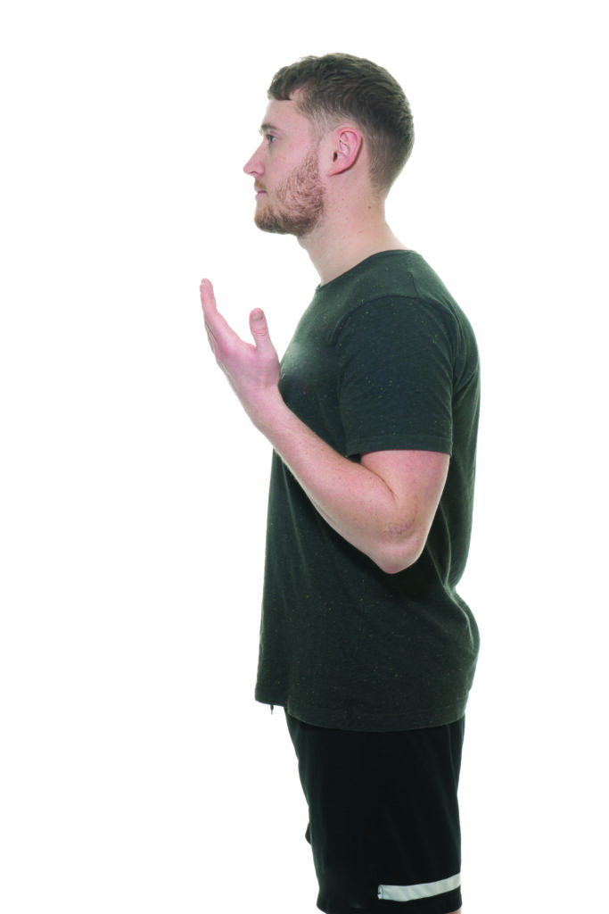 Photograph of a person with their arm bent at the elbow raised upward