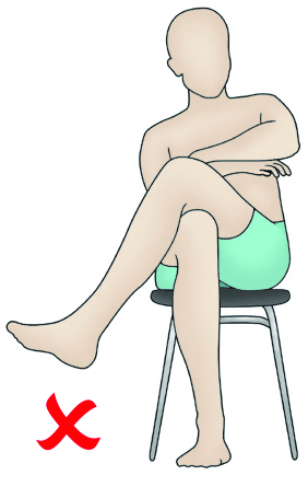 Image showing a person sitting with their legs crossed. This is a movement that needs to be avoided for six weeks (or longer for some people).