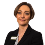 Dr Catherine Hayden headshot. Catherine has short brown hair and she is wearing a black suit jacket, white name badge and blue blouse.