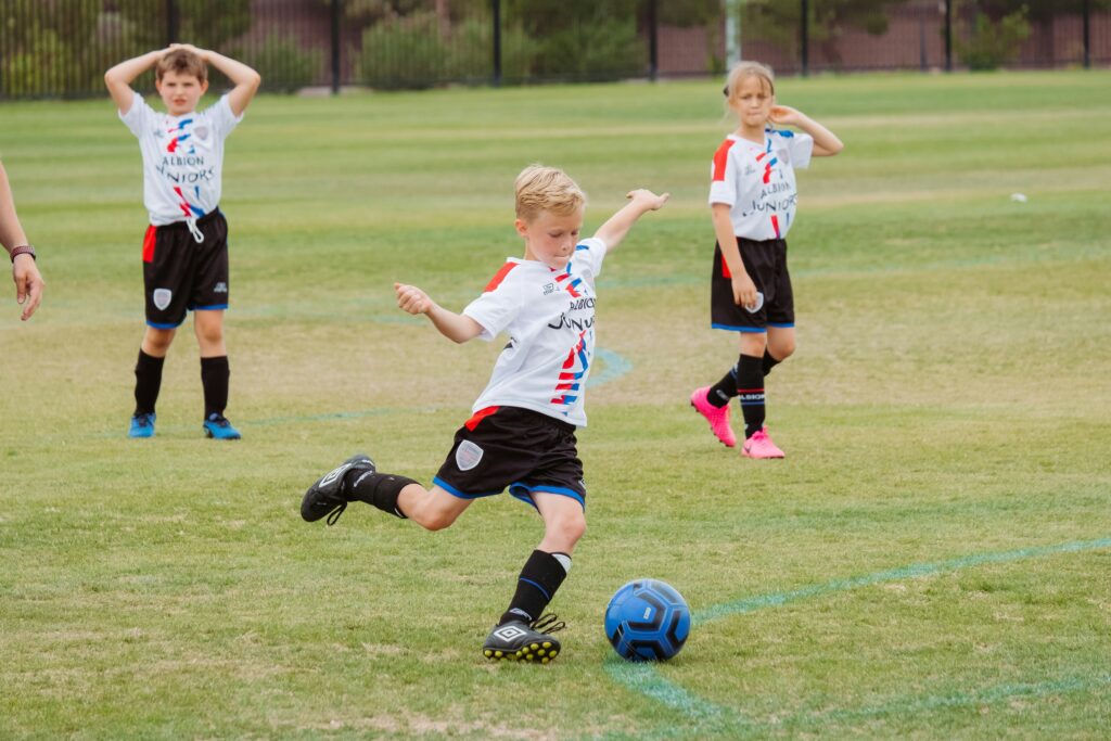 Photograph of a child playing football