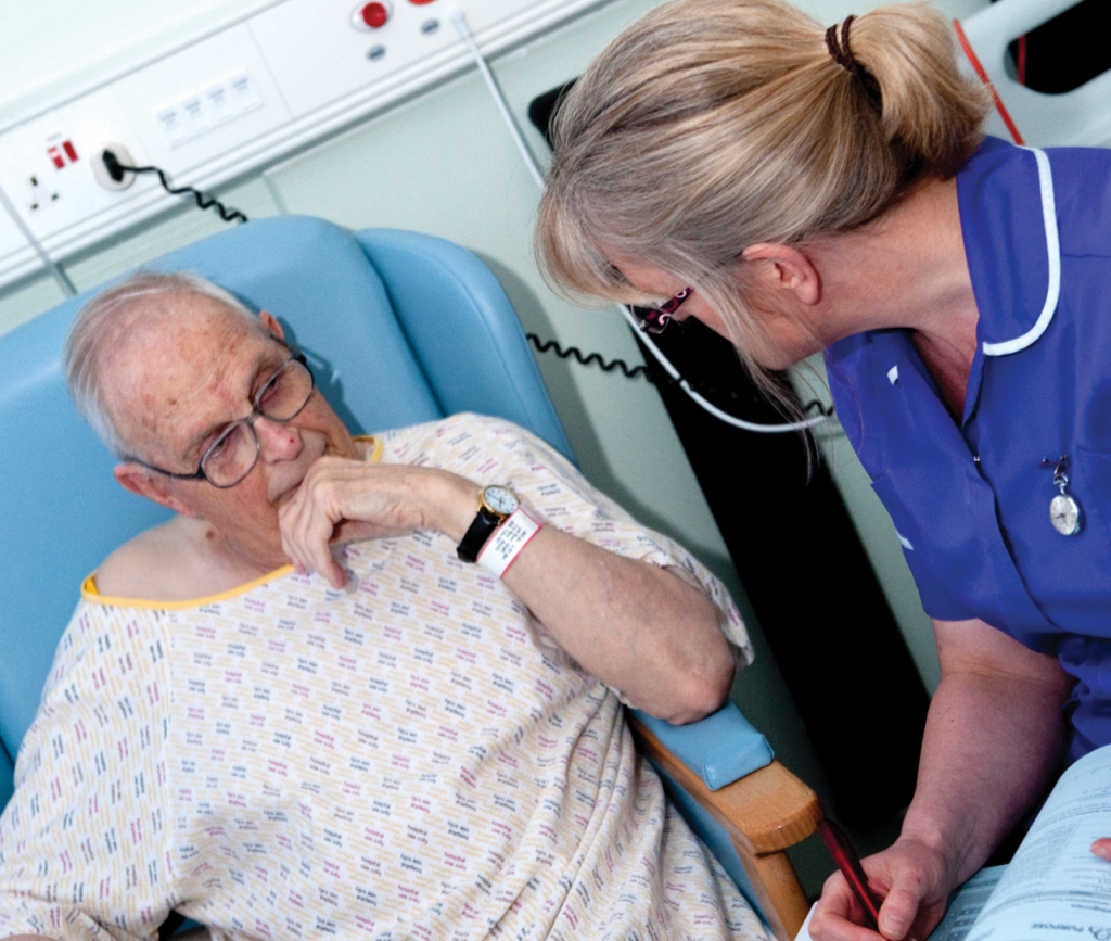 Nurse talking to a male patient about his surgery