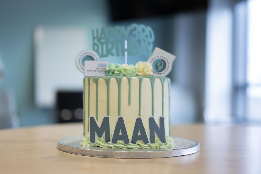 A green and yellow birthday cake,