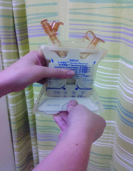 An image showing pulling the lower panel of the J-VAC towards the user