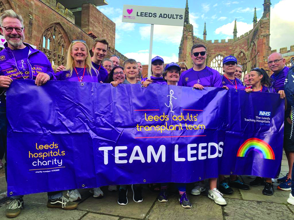 Photograph of the 'Leeds team' holding a banner at the transplant games.