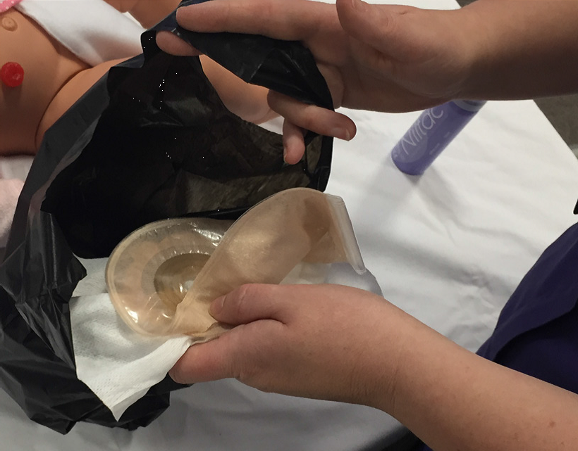 Photo showing the pouch being placed in a disposable waste bag