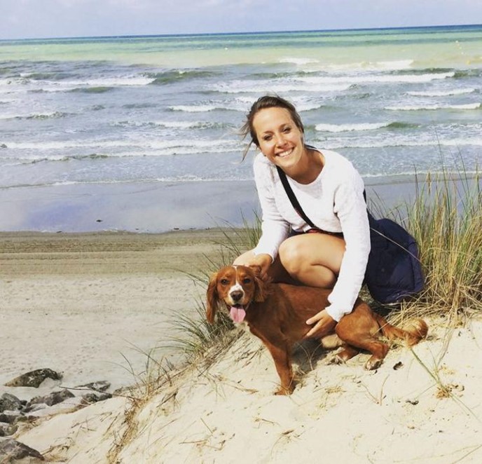 Laura, a living donor, on a beach, with her dog