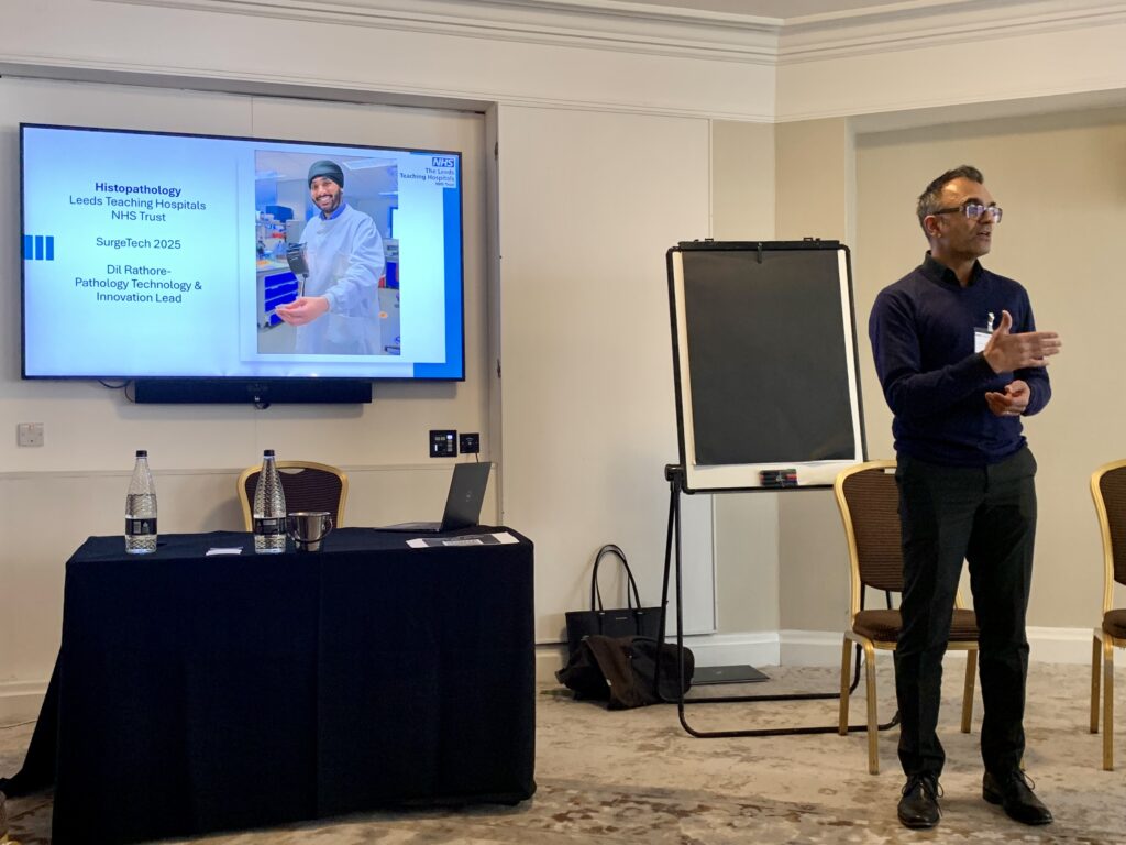 A photo of Moninder Bhogal presenting to at the SurgTech conference during his session.