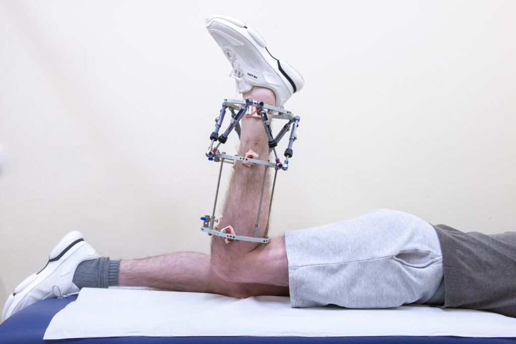 Photograph demonstrating Hip Extension exercise.
Lie on your stomach keeping your back straight and your hips level, bend the knee of your frame leg to about 90 degrees. 
Keeping the knee bent, raise the foot up and backwards.
Keeping the knee bent, lower the foot.
Repeat 10 times.