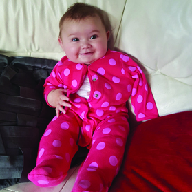 Picture of a child in a babygrow following nerve surgery.
