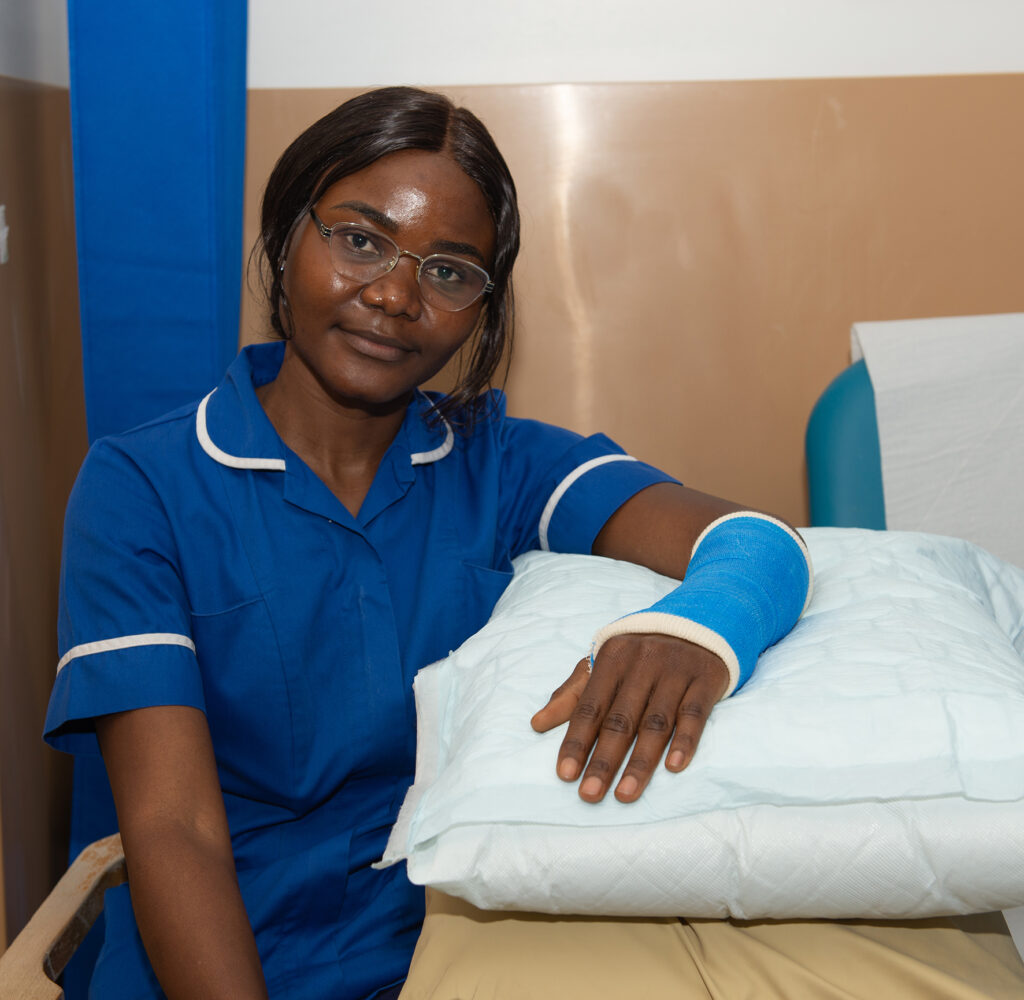 Example of how to elevate your arm when you are sat - rest your arm on a pillow that raises your arm to about the level of your heart