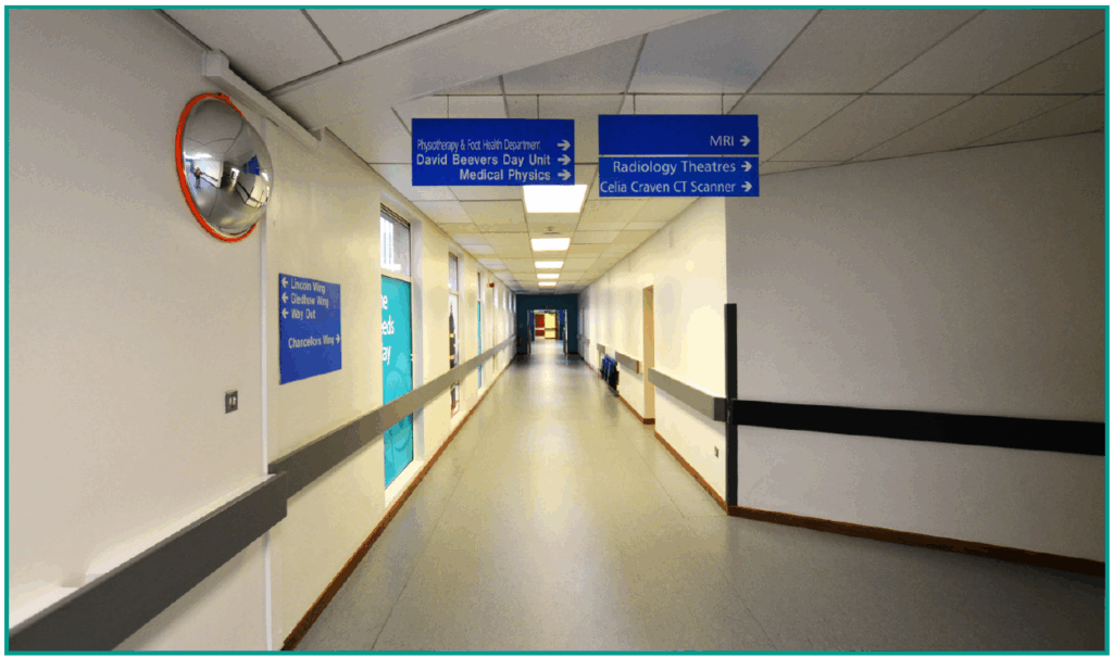 An image of the corridor past the &lsquo;Leeds Way&rsquo; posters.