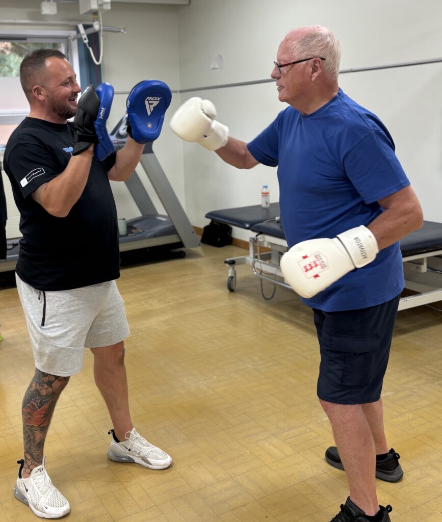 Chris Walsh (Director of Trident Fitness) and patient Michael Creedon sparring with boxing gloves on. 