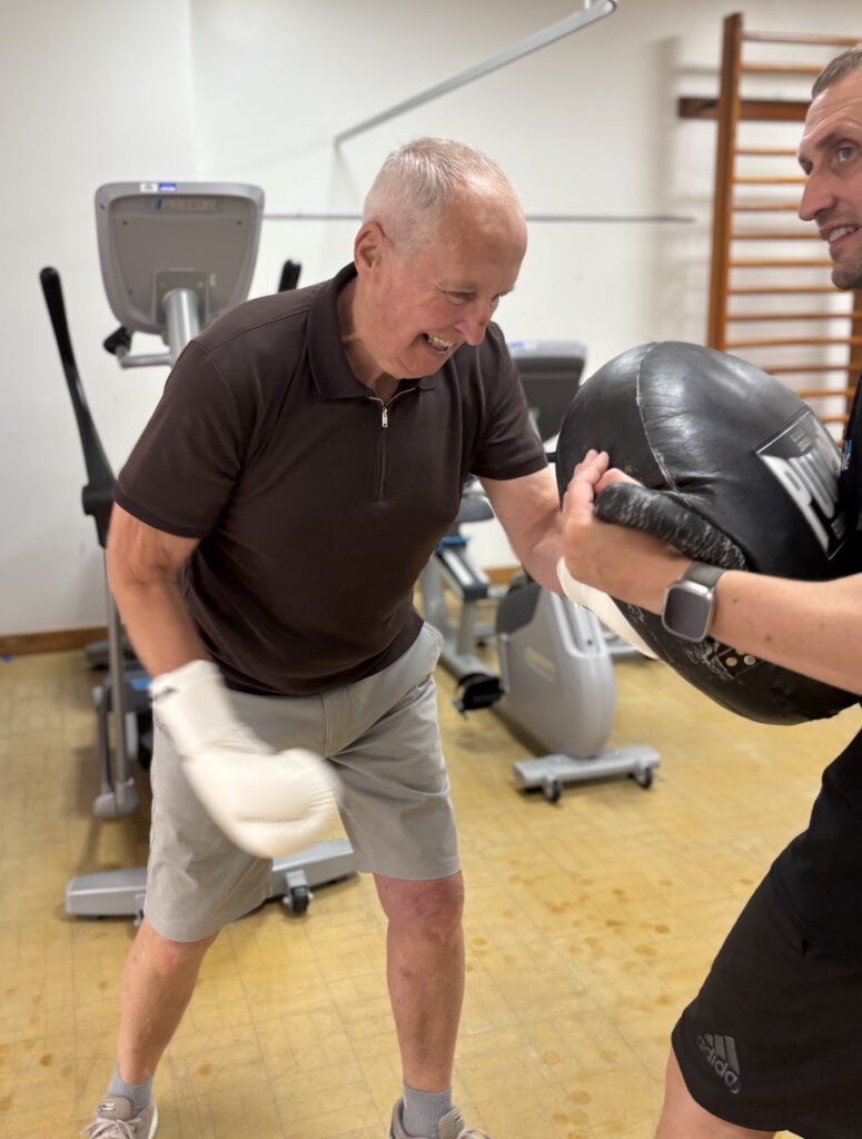  Patient Paul Sharp and Joe Gledhill (Director of Trident Fitness), sparring with boxing gloves and pads 