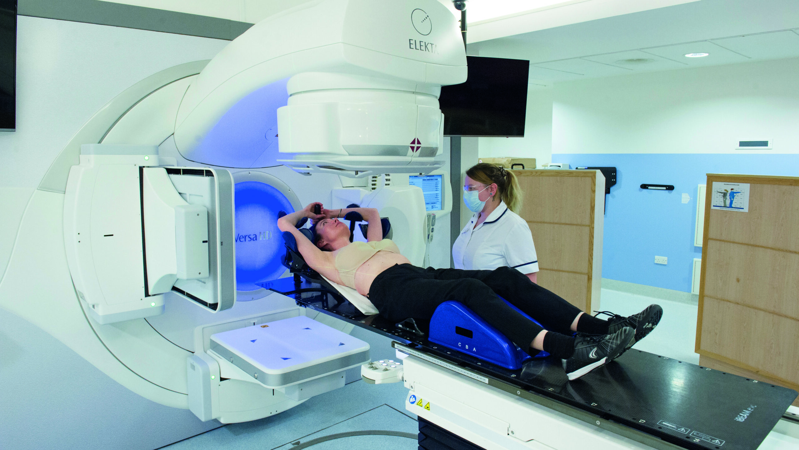 Image showing two arms up breast set up linac wider view.