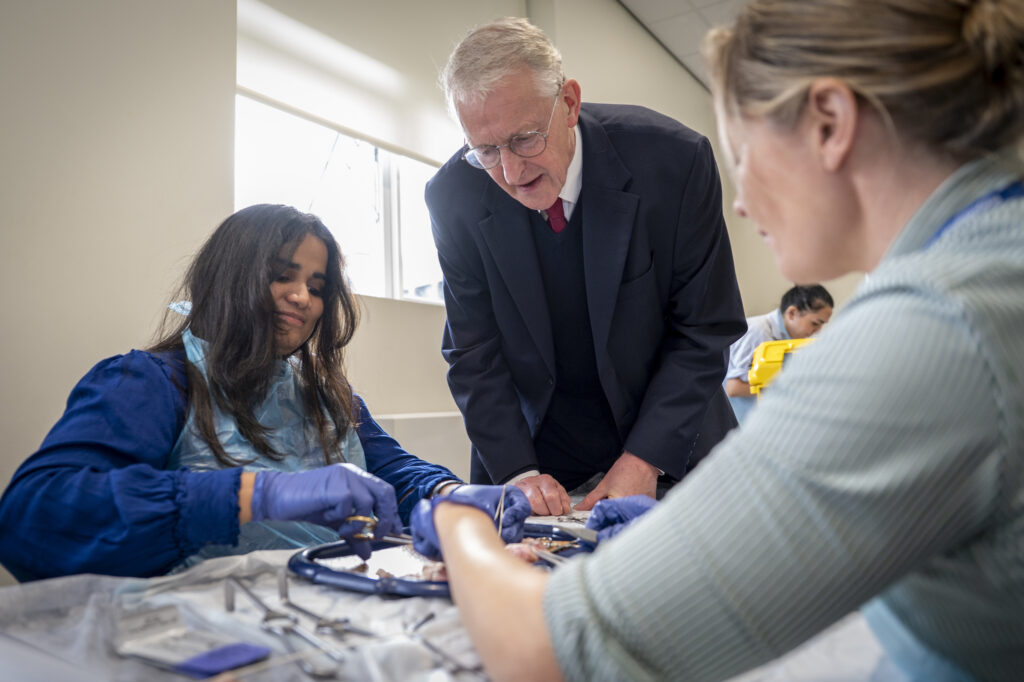 Hilary Benn MP observes two trainees practising surgical techniques during a hands-on session at the Urology Simulation Boot Camp at Leeds Teaching Hospitals.