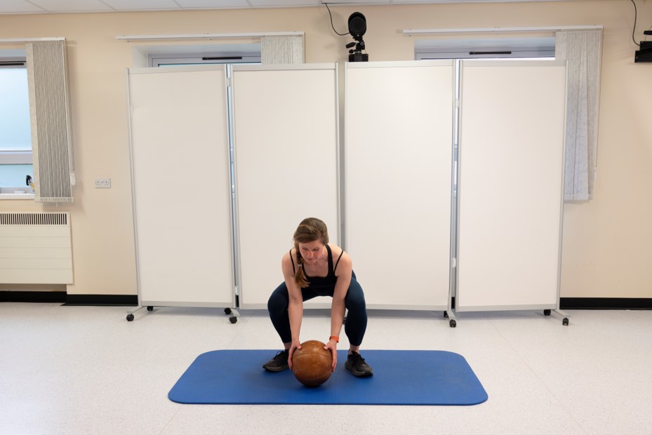 Starting in squat position holding&nbsp;with both hands&nbsp;5kg medicine ball that is touching&nbsp;ground.&nbsp;&nbsp;