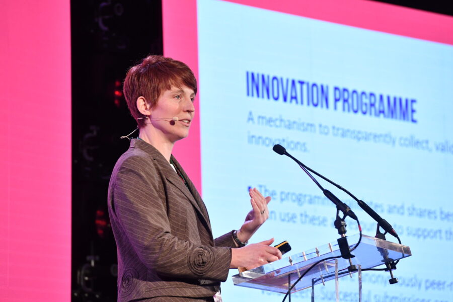 Photo o fJenny Ehrhardt speaking at an innovation conference.