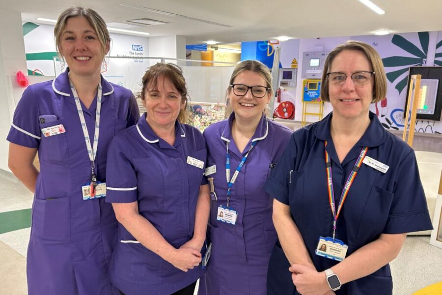 Four staff members in nursing uniforms.