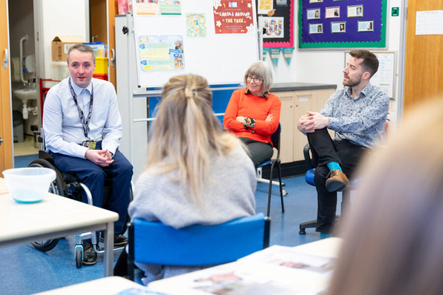 Joshua talking to teaching staff.