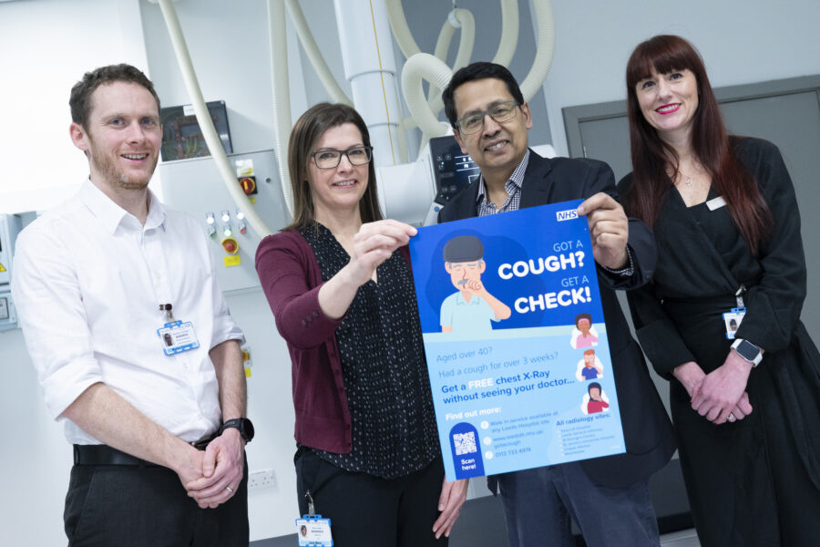 Four members of the NHS team holding a poster promoting the self-request chest x-ray service