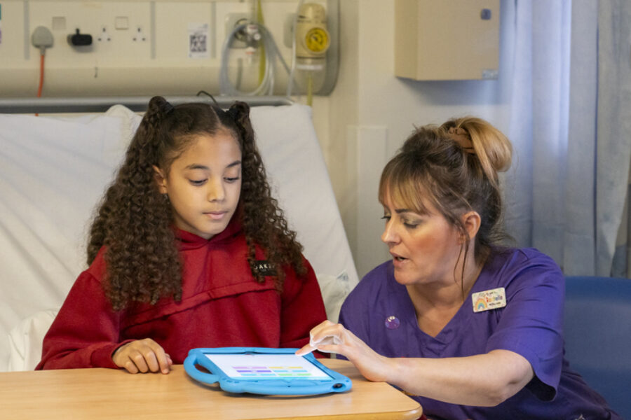 An image of a healthcare worker and a paediatric patient using the app via a tablet.