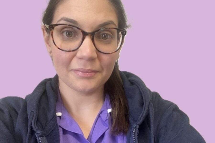 Picture of Eleni wearing her purple clinical unifiorm