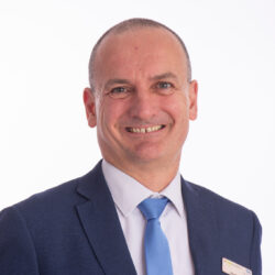 Tim Hiles, Interim Operating Officer wearing blue suit and tie