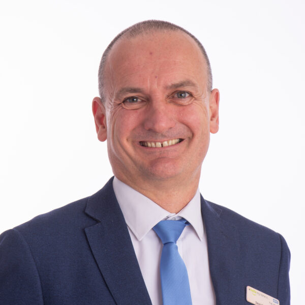 Tim Hiles, Interim Operating Officer wearing blue suit and tie