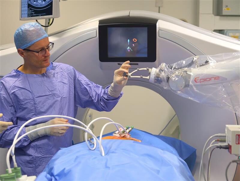 medical professional using robotic machine in theatre