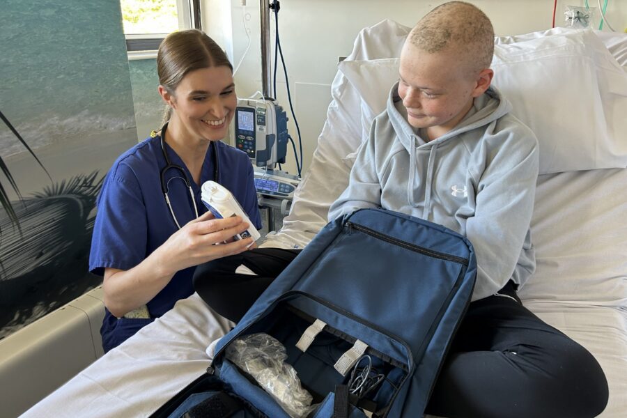 Dr Jennifer Fox with patient Oscar (17) setting up an AC backpack